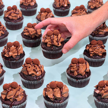 Chocolate Cupcakes with rich sponge, smooth buttercream, ganache drizzle, and handmade truffles by Crumbs & Doilies.